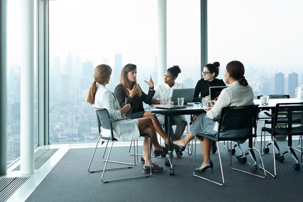 1128218442 Business people in large modern meeting room